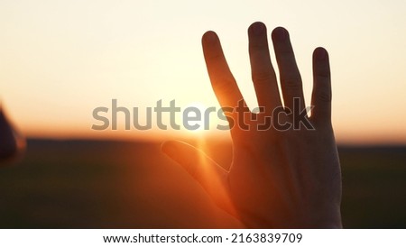 man hand silhouette sunlight. Muslim with man hand sun on light background. christian business love religion concept. christianity and religion belief in god. man sunlight hand reaches for sun god Royalty-Free Stock Photo #2163839709
