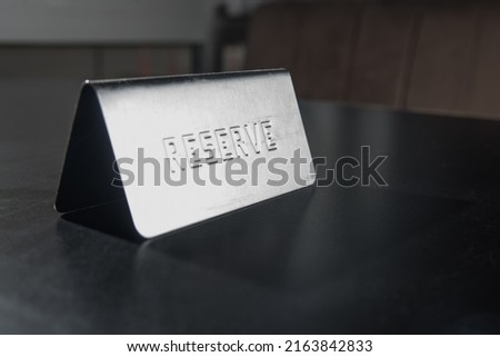 Reserve silver plate on a table perspective closeup with flashlight
