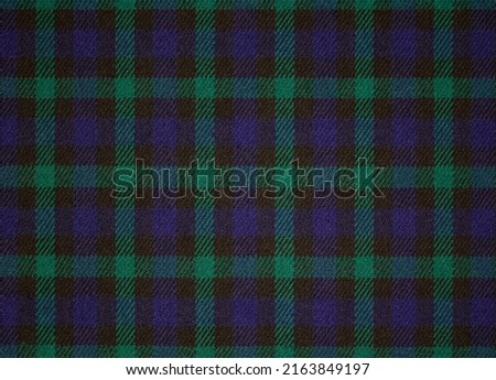 A sample of wool suit fabric tartan. Checkered background with a close-up image of textiles.  Royalty-Free Stock Photo #2163849197