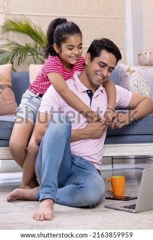 Daughter embracing her father at home