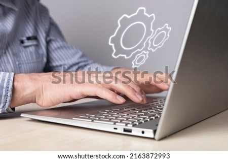Man installing, configuring system settings at laptop. Computer repair, technical support concept. Sysadmin or IT administrator profession. High quality photo Royalty-Free Stock Photo #2163872993