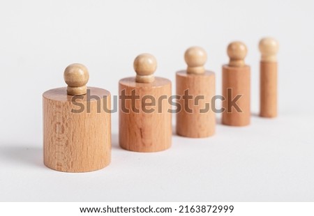 Montessori knobbed wooden cylinders row of different size from thick to thin. Children game. High quality photo