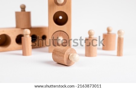 Montessori knobbed wooden cylinders with blocks. Kids puzzle for development of eye hand coordination and concentration. High quality photo