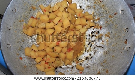 Cube potato, Fried raw cut into square pieces with sour cabbage, preparing fresh, cooked stir-fry on a frying pan, for a side dish, delicious, close up photo background.