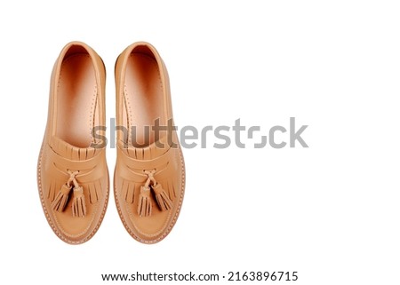 Leather women's light brown shoes standing together, isolated on a white background.Sale of seasonal women's classic shoes, business-style shoes.Care of genuine leather shoes, repair shop.Copyspace Royalty-Free Stock Photo #2163896715