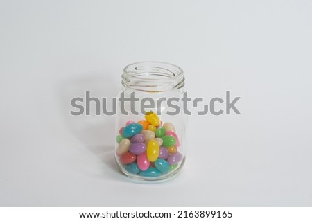 Glass jar with coloured candy for children