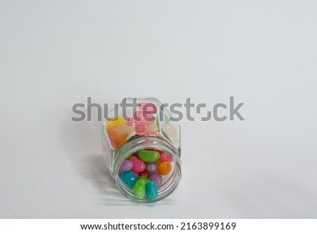 Glass jar with coloured candy for children