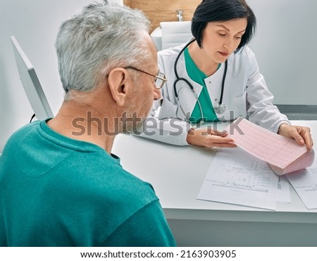 Diagnostic heart diseases, heart attacks, and tachycardia in elderly people. Doctor consulting senior man on results of his cardiogram and test Royalty-Free Stock Photo #2163903905