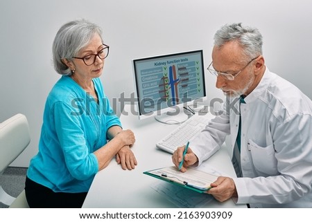 Senior woman during a consultation with a urologist about kidney disease and treatment at medical clinic. Kidneys health Royalty-Free Stock Photo #2163903909