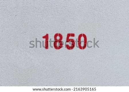 Red Number 1850 on the white wall. Spray paint.
