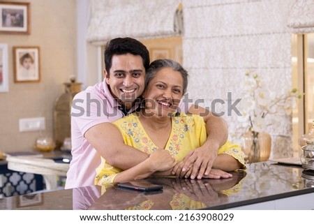 Happy Indian mother and son spending leisure time at home