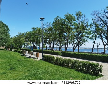 on the Volgograd embankment there is a lawn, paths, large trees Royalty-Free Stock Photo #2163908729