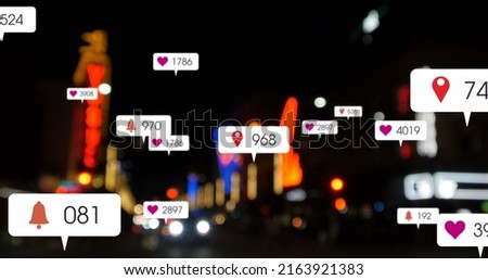 Image of social media icons and numbers over out of focus city and car lights. global social media, connections and digital interface concept digitally generated image.
