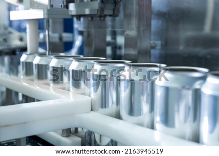 Empty new aluminum cans for drink process in factory line on conveyor belt machine at beverage manufacturing. food and beverage industrial business concept. High quality photo Royalty-Free Stock Photo #2163945519