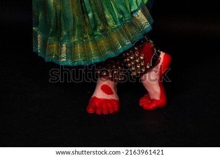 Legs of an Indian dancer. Oriental transport. Close-up of walking on a black background