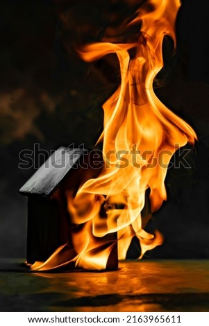 the house is on fire on a dark background. background picture. Soft and selective focus.