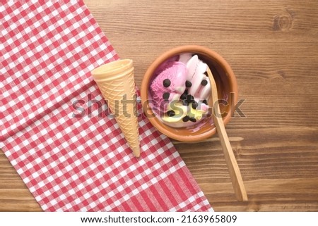 fruit ice cream in a bowl on wooden table