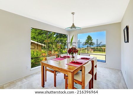 House interior. Bright room with dining table set and beautiful window view