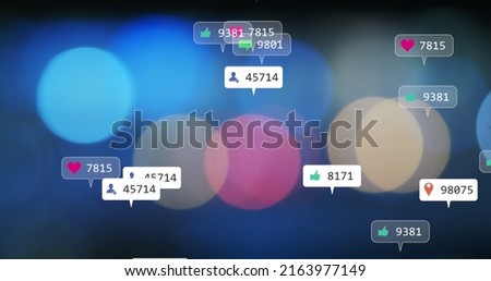 Image of social media icons and numbers over out of focus flickering lights. global social media, connections and digital interface concept digitally generated image.