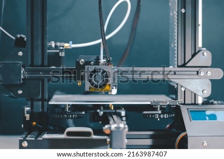 3D printing machine, 3D printer prints a new model Royalty-Free Stock Photo #2163987407