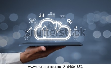 Creative background, a male hand with the iPad, the image of the hologram of the cloud, blue background. The concept of cloud technology, cloud storage, and a new generation of networks. Mixed media.