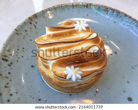 Abstract photo of Lemon meringue tart is a type of dessert tart, consisting of a shortened pastry base filled with lemon curd with toasty meringue topping has balanced flavour between sweet and sour.