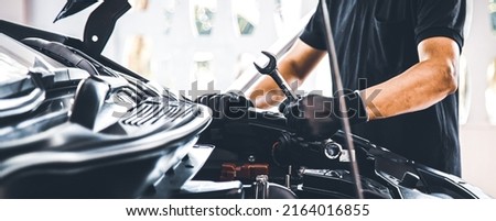 Close-up hand auto mechanic using the wrench to repairing car engine problem. Concepts of check and fix car and maintenance servicing. Royalty-Free Stock Photo #2164016855