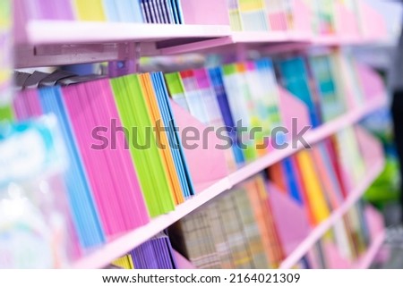 Lots of children's books on the shelves in a variety of colors.