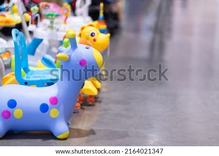 Children's toys, rubber dolls bounce off the bright floor.