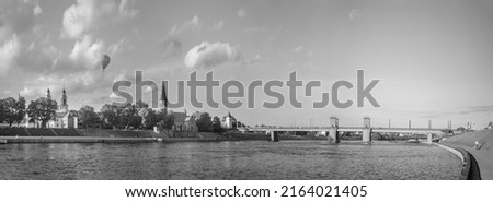 Bridge on river Nemunas in Kaunas city on sunny cloudy evening in summer. Lithuania.Black white.