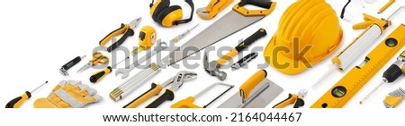 Construction work tools for building. Yellow hard hat with work equipment isolated on white background. Layout for home service repair concept or hardware store showcase banner.Top view set of objects Royalty-Free Stock Photo #2164044467