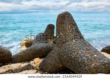 Close-up view of the old tetrapods near the white rocks of the village of Gagra. Abkhazia.