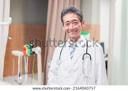 Elderly male doctor working at the hospital