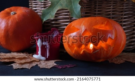 Jack-o-lantern pumpkin orange light, on wooden background. Halloween background. 