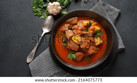 Beef goulash, soup and a stew, made of beef chuck steak, potatoes and plenty of paprika. Hungarian  traditional meal. Royalty-Free Stock Photo #2164075773