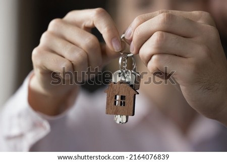 Unknown couple hands holding bunch of keys, close up view. Concept of affordable dwelling bank loan for young family, relocation day, start new life at own or rented house, first real-estate purchase Royalty-Free Stock Photo #2164076839