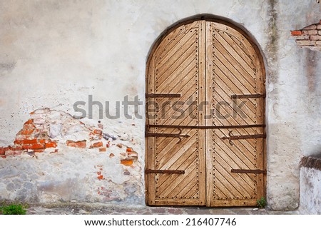 Wooden door in an old style. Courtyard of the old castle