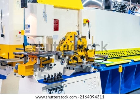 Compact hydraulic punch shear bender and notching machine for cutting various shape metal e.g. round bar angle bending square flat plate u channel etc. of manufacturing process in industrial Royalty-Free Stock Photo #2164094311
