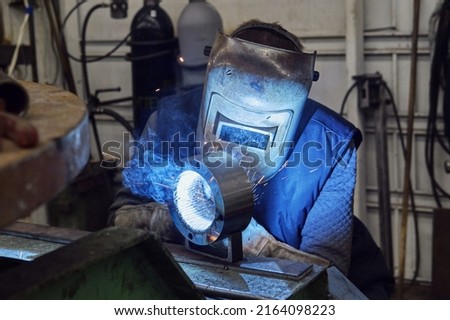 work of a welder with a complex technological part