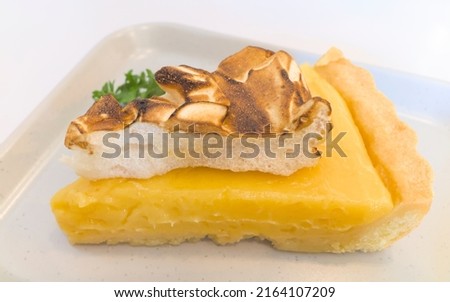 Abstract selective  focus photo of Lemon meringue pie is a type of dessert pie, consisting of a shortened pastry base filled with lemon curd with toasty meringue topping