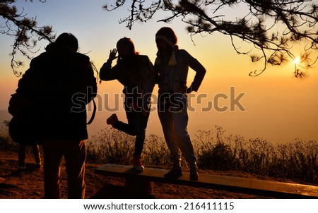 Silhouette people taking photo in the morning , Phu Rua, Loei in Thailand, Sunrise at the mountain view with tourism