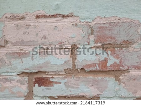 Decorative background of a brick wall with old paint