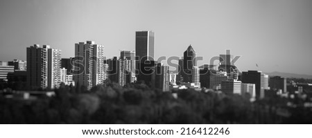 Black and white downtown Portland cityscape from unique perspective taken with tilt shift lens during sunny day