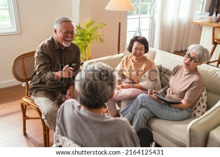 old senior asian friends retired people hapiness positive laugh smile conversation together at living room at nursing home Seniors participating in Group Activities in Adult Daycare Center  Royalty-Free Stock Photo #2164125431