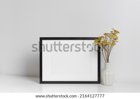 Blank frame mockup in white minimalistic room with copy space for artwork, photo or print presentation