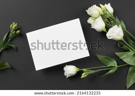 Invitation card mockup with white eustoma flowers on black