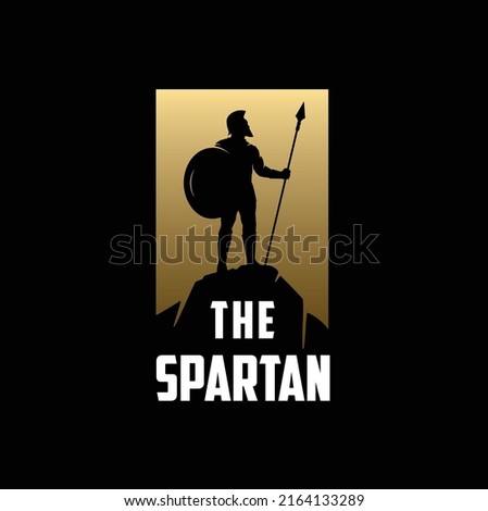 Silhouette of Spartan Knight Soldier, Greek Warrior standing with the spear on top cliff after a war battle Royalty-Free Stock Photo #2164133289