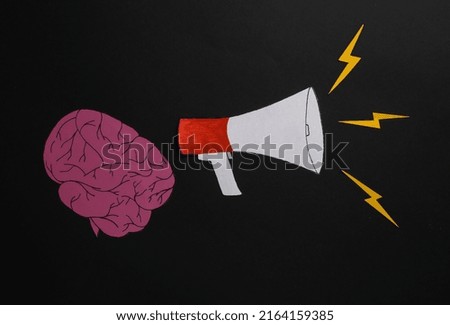 Brain with megaphone on black background