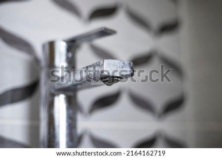 Dirty faucet with limescale, calcified water tap with lime scale on washbowl in bathroom Royalty-Free Stock Photo #2164162719