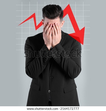 Upset businessman and illustration of falling down chart on light grey background. Economy recession concept Royalty-Free Stock Photo #2164172777
